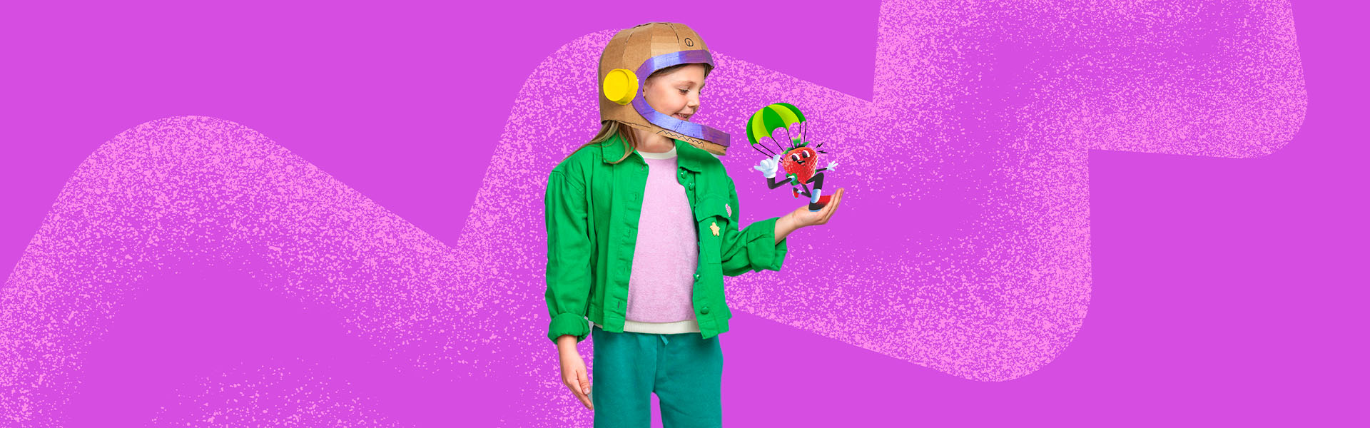 Kid with helmet holding a dancing strawberry with parachute on it